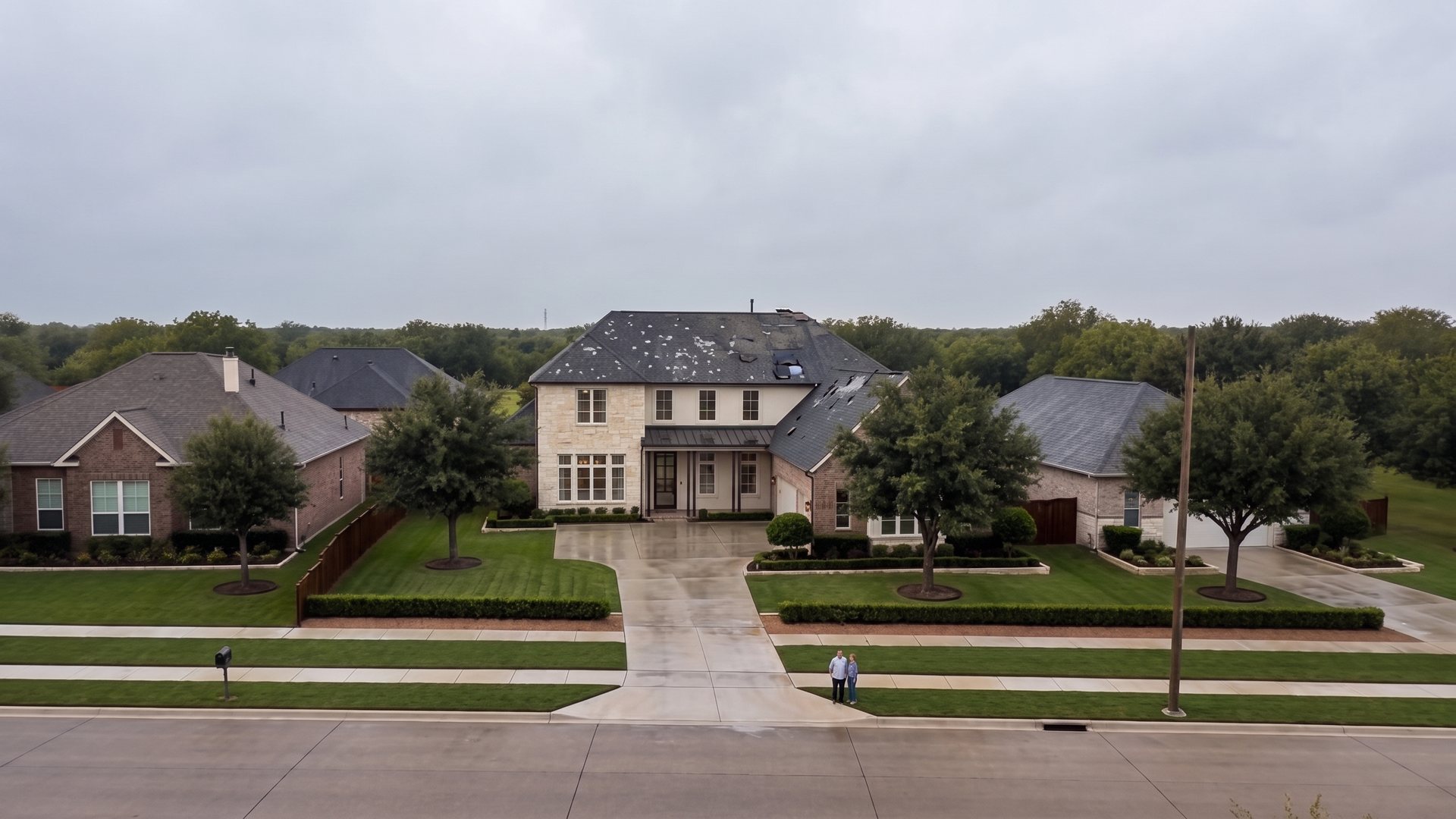 The same Texas home with a storm-damaged roof showing hail bruising and lifted shingles.
