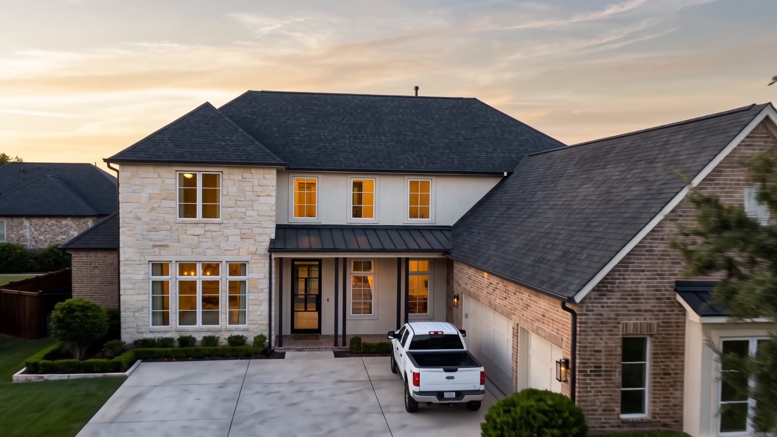 Placeholder frame: aerial view of a completed roof at dusk.